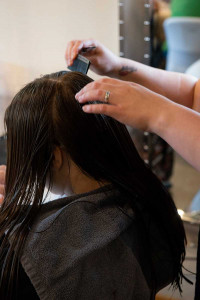 Youth from Janie's Fund getting her hair done