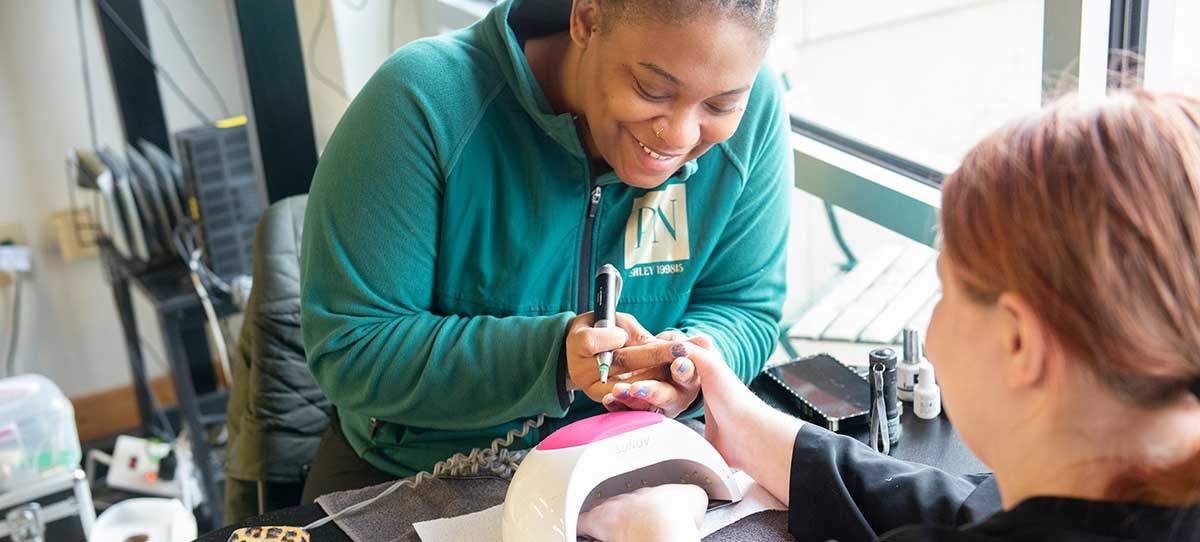 Youth from Janie's Fund getting her nails done