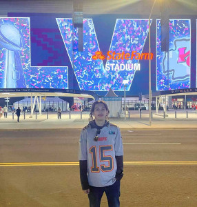 Max in front of football stadium