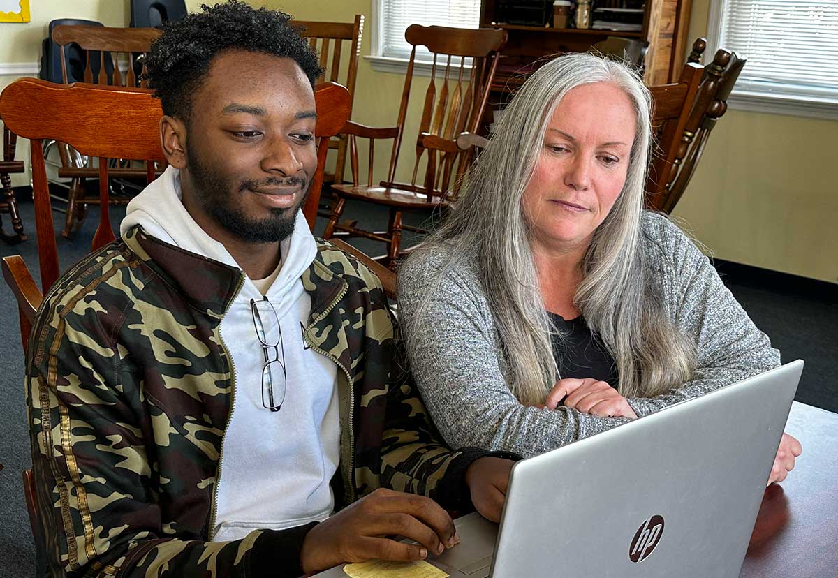 Niziere and his specialist working from a laptop