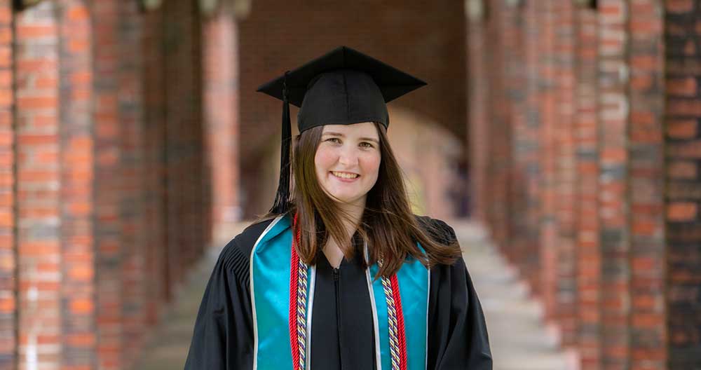 LifeSet participant and Scholar, Abby with graduation cap and gown