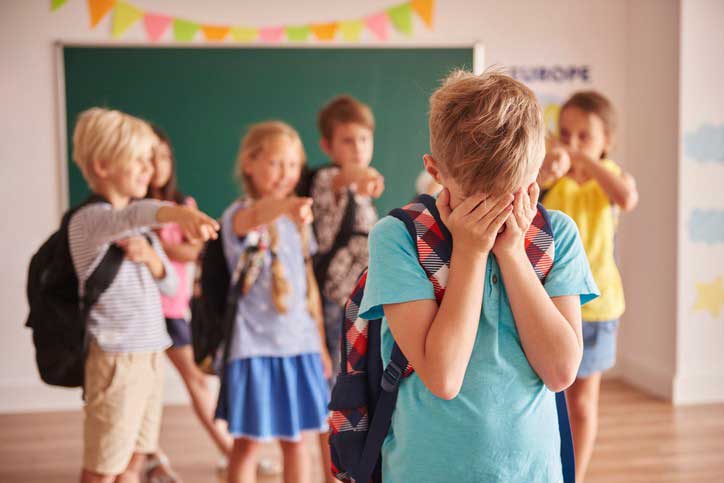 youth being bullied by other kids in classroom