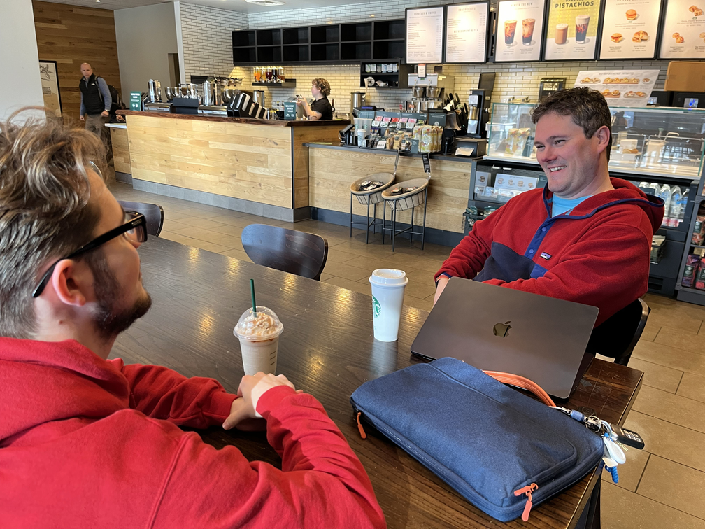 Adam and Christian having coffee laughing