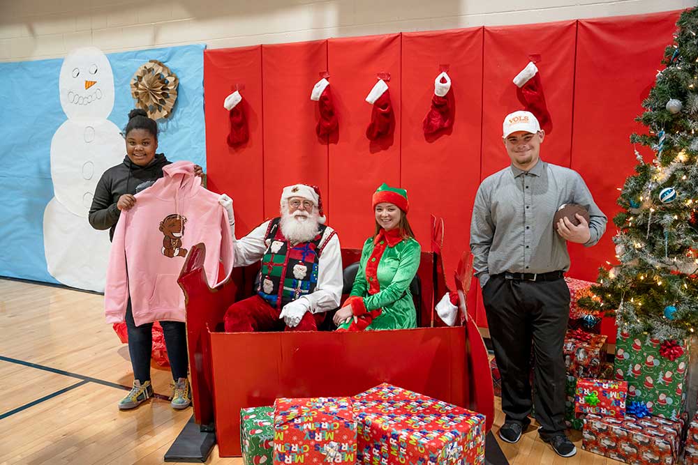 Youth Villages kids meet Santa and an elf at the Dogwood Holiday Heroes party.