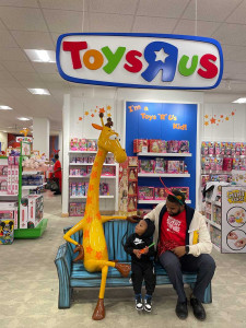 young toddler and his father at Toys R Us