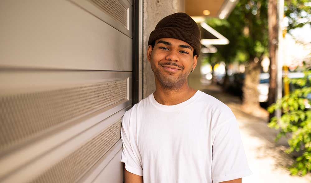 LifeSet participant, DJ standing against a wall