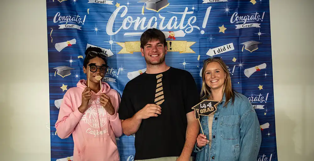 ILP Specialist Savannah; ILP graduate and newest Youth Villages Oregon employee, Ethan; and Ethan’s former specialist and current Hiring Coordinator, Emma at a graduation party