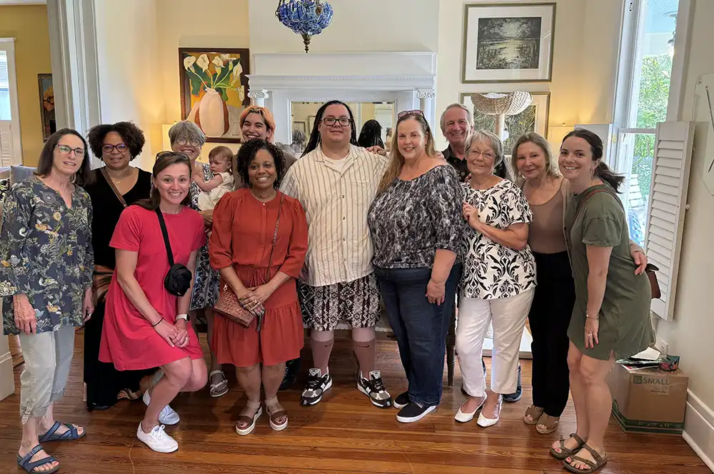 Tristan at his graduation party with his mentors and Youth Villages staff