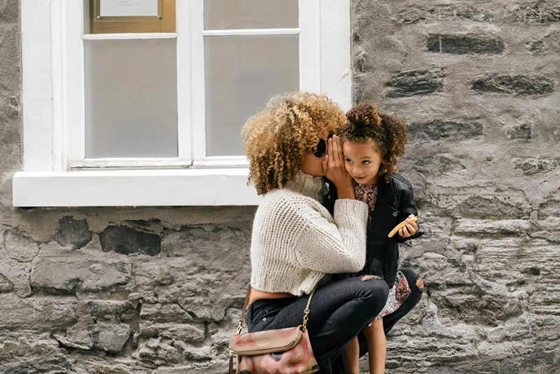 mother holding daughter