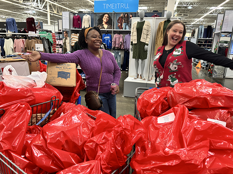 corporate sponsors and volunteers helping shop for Christmas gifts