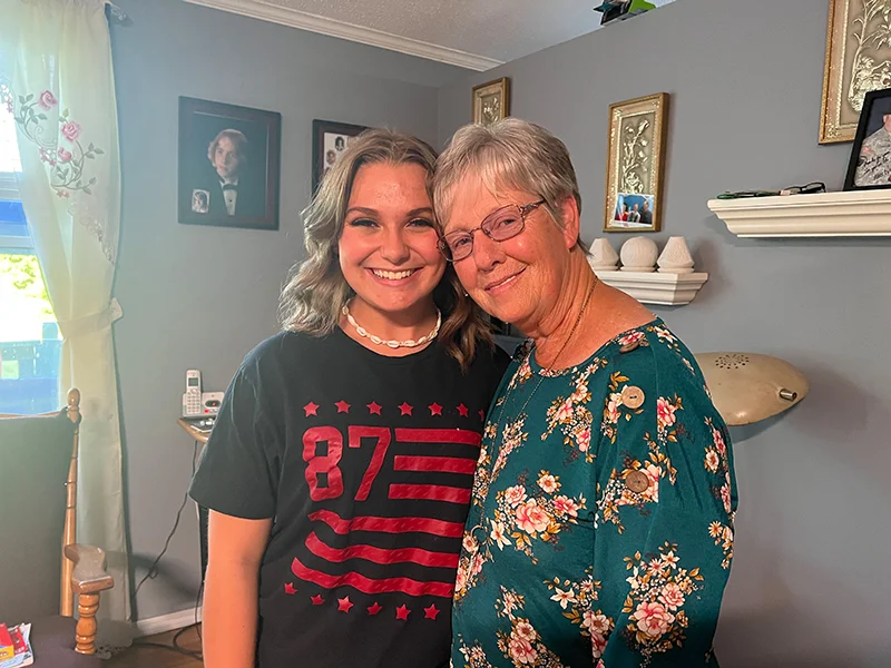 Intercept participants, Grandmother and granddaughter pose for a photo in their living room