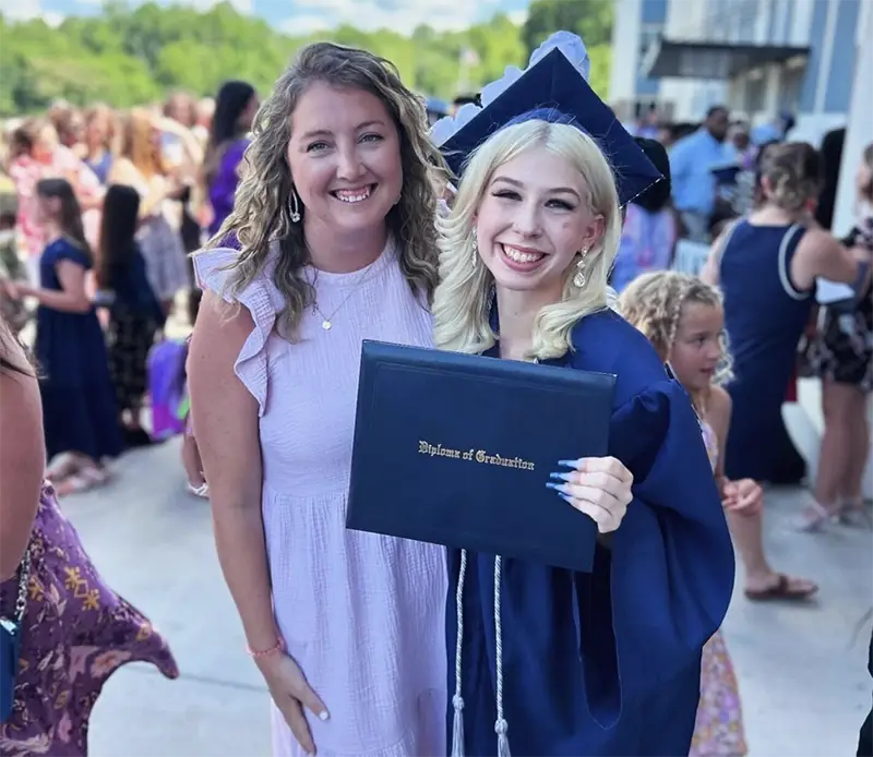 Jailyn at graduation with diploma